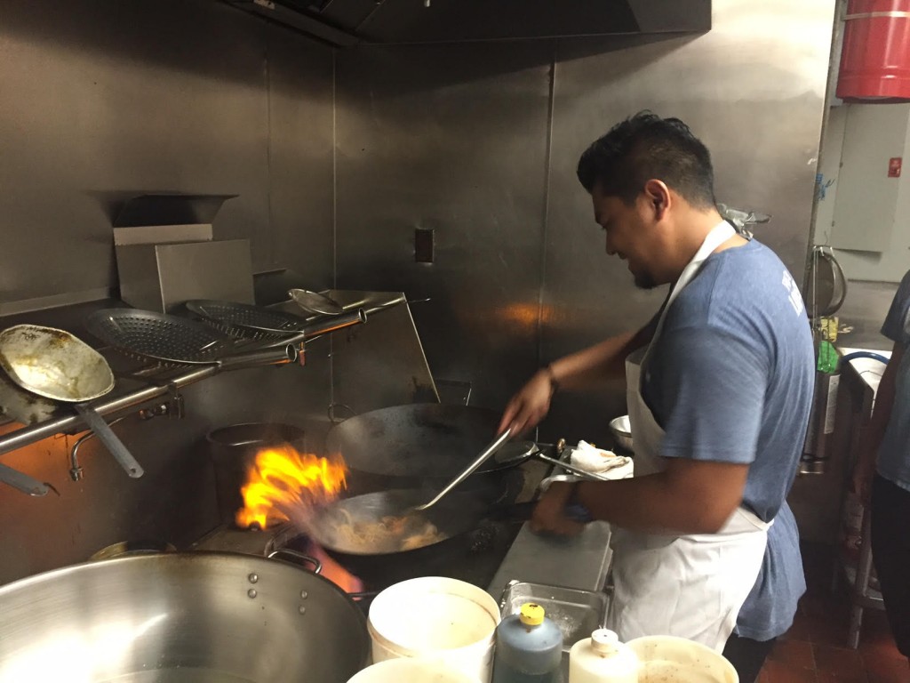 Chef San stir-frying beef lo mein in a wok at BarLy (photo by Lee Porter)